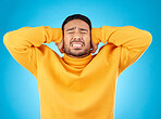 Stress, headache and hands on ears of man in studio with noise, complaint or crisis on blue background. Anxiety, migraine and frustrated male with vertigo, brain fog or tinnitus, depression or trauma