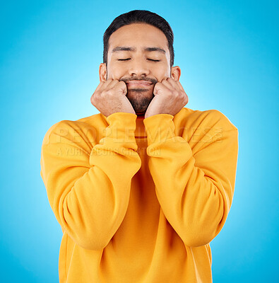 Buy stock photo Man, shy and touching cheeks in studio isolated on a blue background. Peace, calm and person in love, relax for zen and meditation, content and satisfied with eyes closed, hands on face and wellness