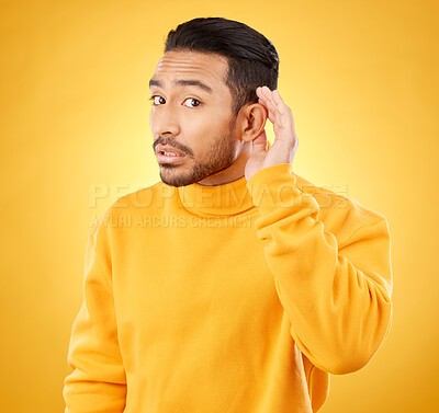 Buy stock photo Gossip, whisper and man portrait with hand on ear in studio for speak up body language on yellow background. Secret, listen and face of guy with privacy, news or confidential coming soon promo 