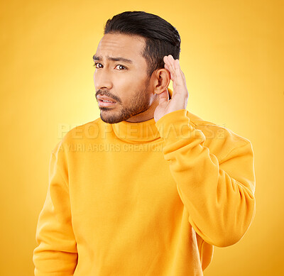 Buy stock photo Whisper, gossip and asian man with hand on ear in studio for speak up body language on yellow background. Secret, listen and male person with hush, news or confidential coming soon promo announcement