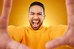 Shouting, portrait and selfie of angry man in studio isolated on a yellow background. Face, screaming and Asian person taking profile picture for memory in anger, frustrated or stress on social media