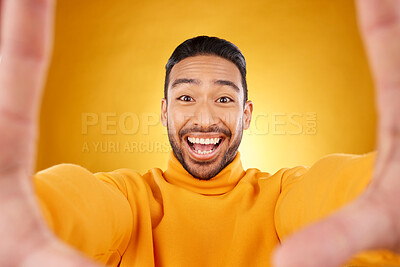 Buy stock photo Excited, portrait and selfie of man in studio isolated on a yellow background. Face, smile and Asian person taking profile picture for happy memory, funny or influencer laughing for social media post