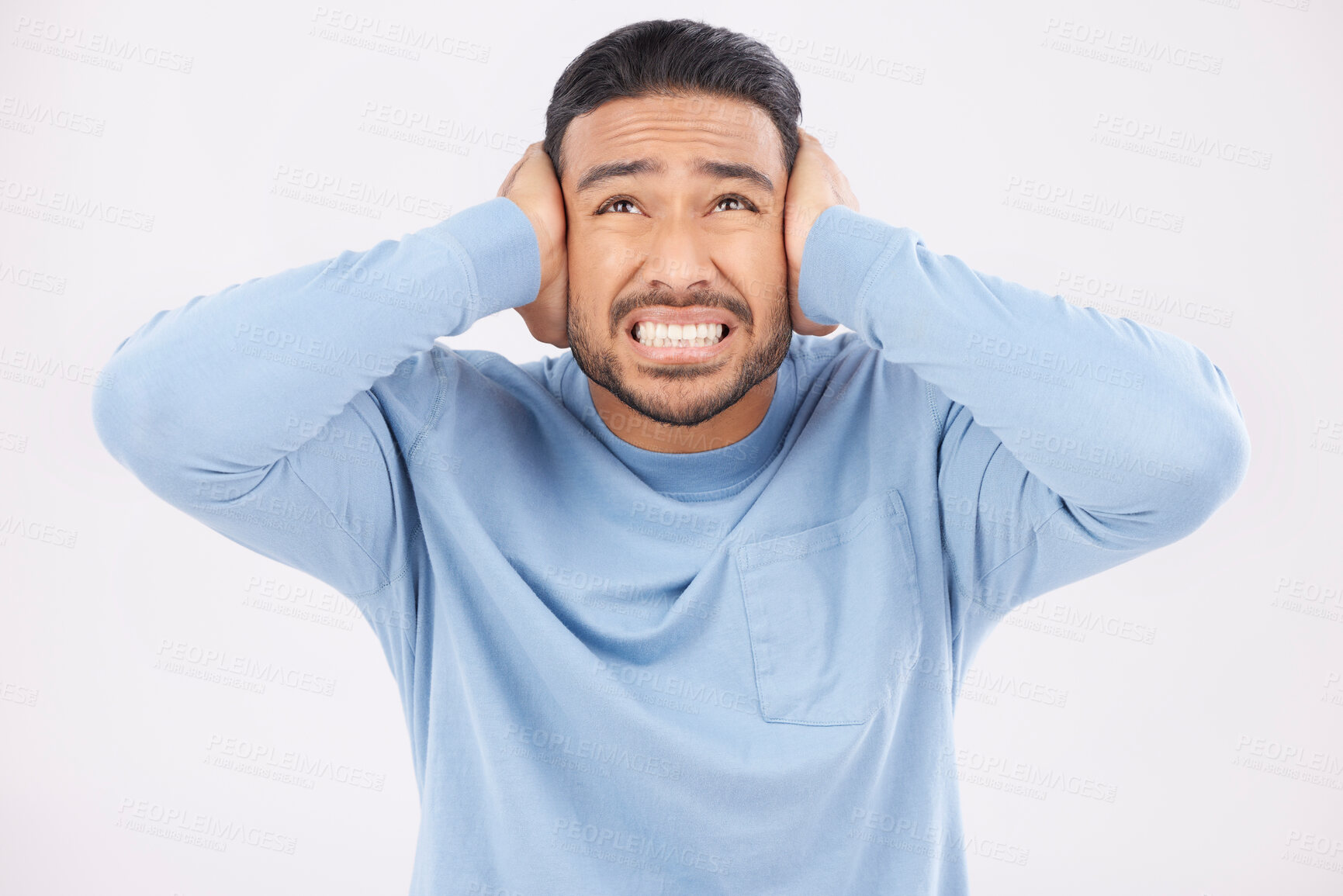 Buy stock photo Stress, noise and man with hearing problem in studio isolated on a white background. Tinnitus, frustrated and person with loud sound, crisis and disaster for mental health, anxiety or headache pain