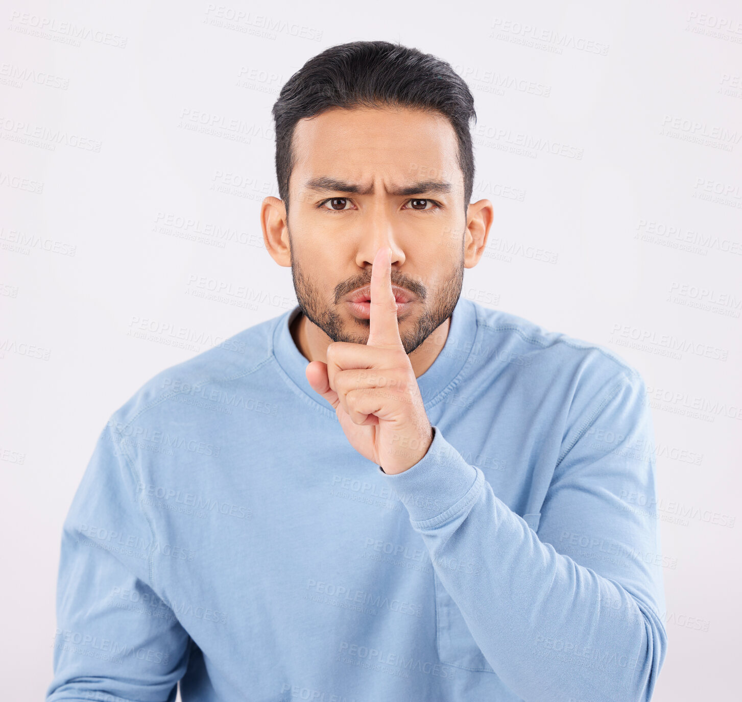 Buy stock photo Whisper, portrait and angry asian man in studio with finger on lips, sign and body language on grey background. Gossip, secret and face of annoyed Japanese male with confidential, privacy or emoji 