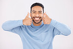 Portrait, thumbs up and asian man in studio happy with hand, sign and thank you on grey background. Smile, face and Japanese male with finger emoji for yes, vote or positive review, feedback or agree