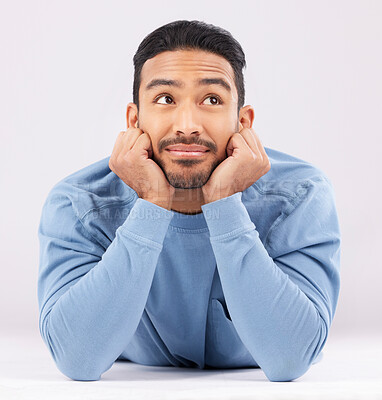 Buy stock photo Memory, thinking and young man in a studio resting on his arms with a problem solving facial expression. Happy, smile and Indian male model with question or dream face isolated by a white background.
