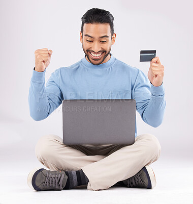 Buy stock photo Celebration, laptop and asian man with credit card in studio excited for cashback bonus on grey background. Online shopping, giveaway and male customer with good news, membership or sign up success