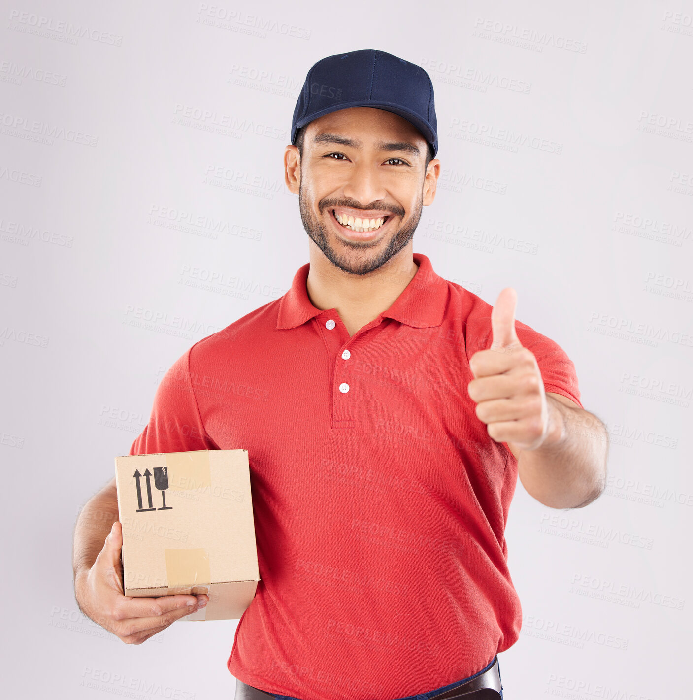 Buy stock photo Courier man, thumbs up and studio portrait with box, delivery company and smile by white background. Supply chain manager, happy and review with icon, emoji or sign language with cardboard package