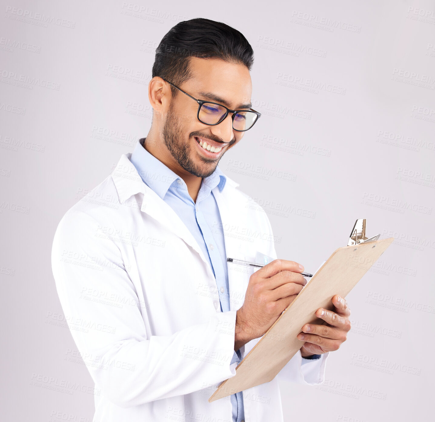 Buy stock photo Happy man, doctor and writing on clipboard in studio, planning documents and healthcare schedule. Asian medical worker with report of insurance checklist, medicine notes or script on white background
