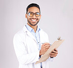 Happy man, portrait or doctor with clipboard in studio, planning notes or healthcare information. Asian medical worker smile with report of insurance checklist, medicine or script on white background