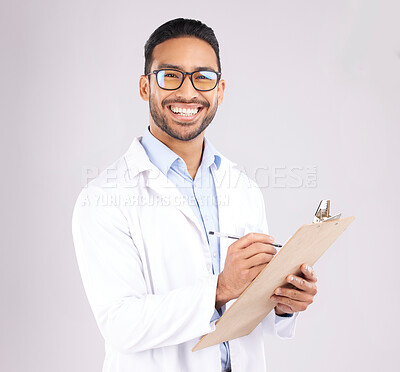 Buy stock photo Happy man, portrait or doctor with clipboard in studio, planning notes or healthcare information. Asian medical worker smile with report of insurance checklist, medicine or script on white background