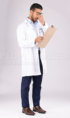 Buy stock photo Burnout, clipboard and man doctor in a studio for a medical diagnosis or wellness treatment. Stress, headache and male healthcare worker with a migraine for checklist isolated by a gray background.