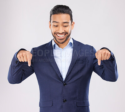 Buy stock photo Down, hand pointing and asian man in studio with sale, announcement or coming soon promo on grey background. Smile, news and Japanese male show launch, platform and giveaway, process or contact info