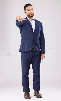 Buy stock photo Thumbs down, disappointed and portrait of business man in studio with upset, unhappy and negative gesture. Emoji, professional and male person with hand gesture for bad review on white background
