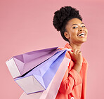 African woman, studio portrait and shopping bag with discount, sale or excited smile by pink background. Young gen z girl, promotion and happy for deal, retail customer experience or fashion for gift