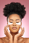 Skin, eye patch or face mask of a woman for dermatology, wellness and skincare glow. Collagen, detox and cosmetics of a black female model with a spa facial for self care on a pink studio background