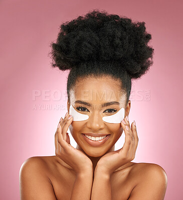 Buy stock photo Skincare, portrait and black woman with patches on eyes, cosmetics and dermatology on pink background. Beauty, collagen and happy model with eye mask for healthy skin glow, smile and care in studio.