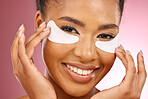 Skincare, portrait and black woman with mask on eyes, cosmetics and dermatology on pink background. Beauty, collagen product and happy model eye patch for healthy skin glow, smile and care in studio.