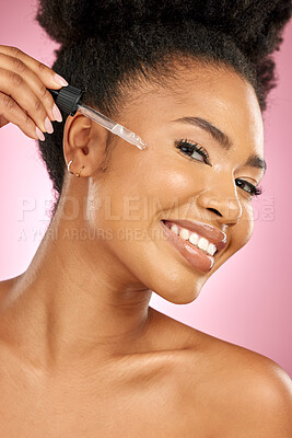 Buy stock photo Black woman, portrait and serum for face in studio, aesthetic skincare and dermatology on pink background. Happy female model, facial cosmetics and dropper of hyaluronic acid, oil and beauty collagen