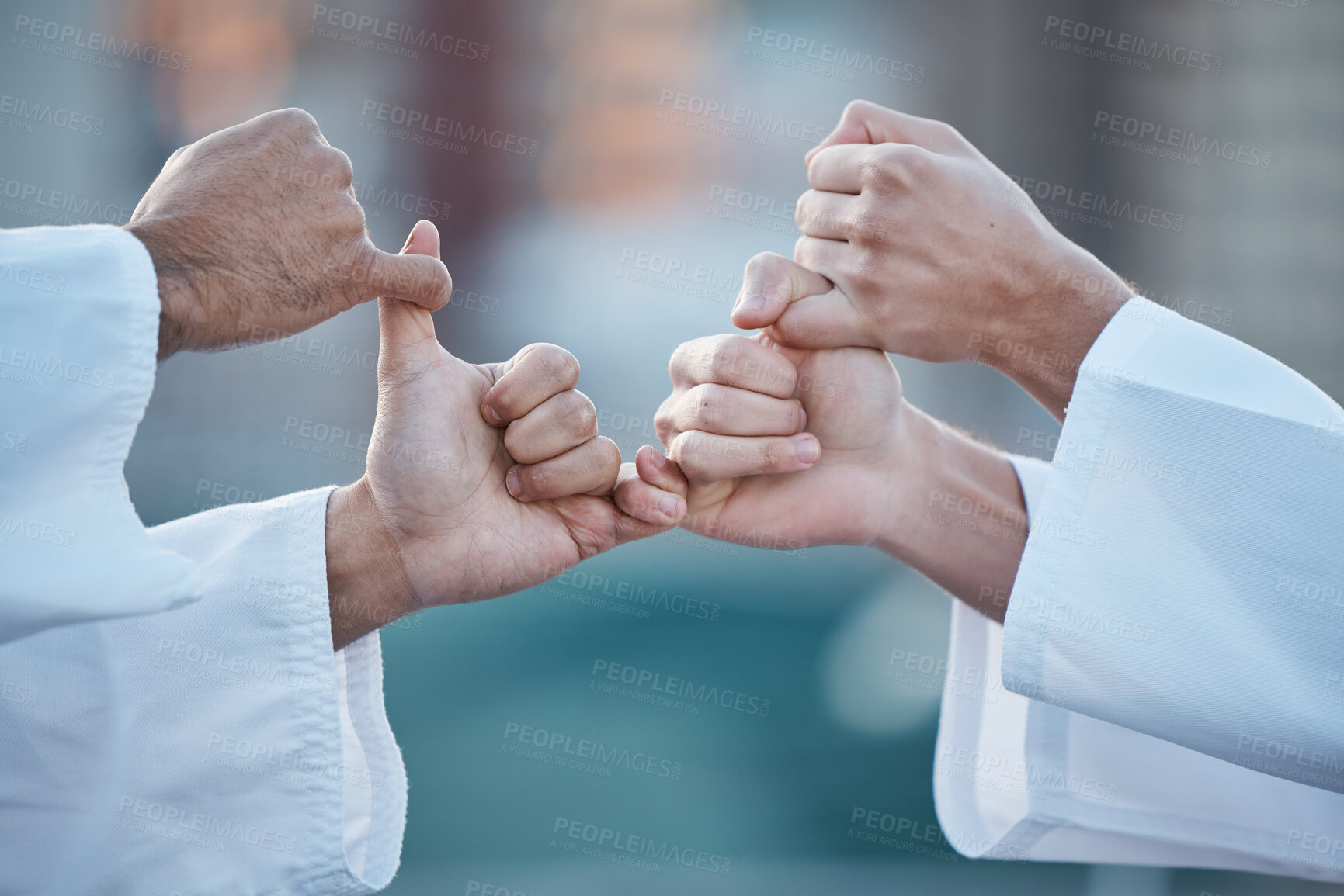 Buy stock photo Hands, karate and grip with sports people fighting outdoor in a competition, battle or combat. Fitness, self defense and thumb war with athletes wrestling while training for martial arts together