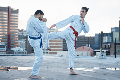 Buy stock photo Men, fight and kick in karate class, training and speed with sparring partner, workout and morning on city rooftop. Martial arts team, contest and fitness with block for exercise, coaching or sports