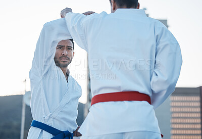 Karate, fight and men in city for exercise, workout and training outdoor. Martial arts, sports and people in competition for taekwondo, serious battle or combat challenge for healthy body in fitness