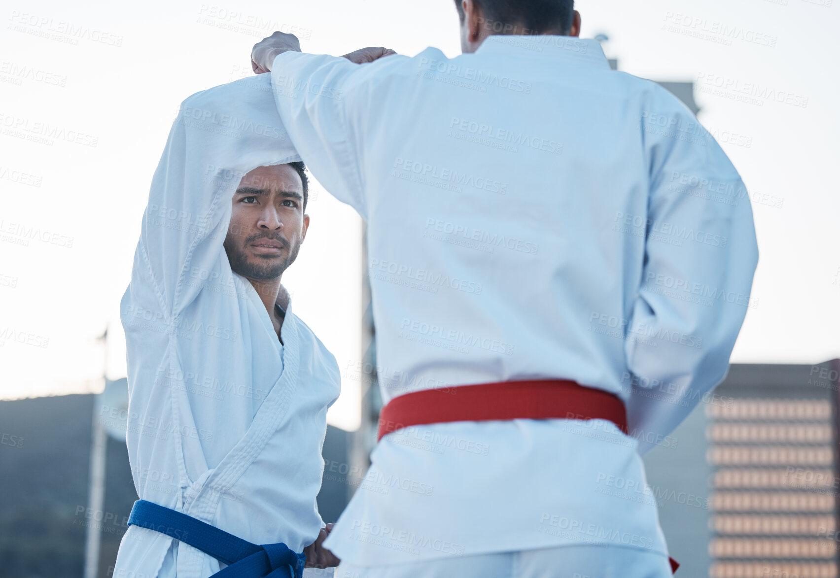 Buy stock photo Karate, fight and men in city for exercise, workout and training outdoor. Martial arts, sports and people in competition for taekwondo, serious battle or combat challenge for healthy body in fitness