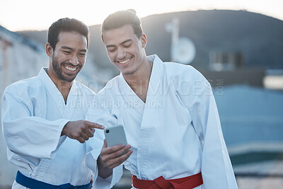 Buy stock photo Men, martial arts or karate class with phone, thinking or pointing at training video on web for development. Fight workout partnership, smartphone or meme with focus for exercise, coaching or sports
