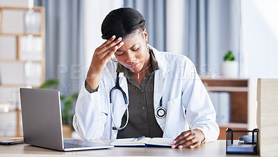 Doctor, African woman and headache with laptop at desk, clinic office or stress with thinking at job. Overworked medic, fatigue and burnout in hospital, book or anxiety for mental health by computer