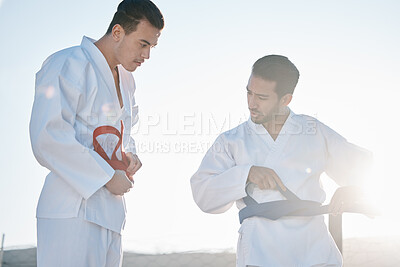 Buy stock photo Karate men, teacher and tie belt with talk, questions and help for clothes, uniform for martial arts class in sunshine. Friends, training and sensei with chat for advice, guide and together for mma