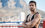 Man, wrestling and arms crossed in portrait for sport, ring and fitness on rooftop, strong muscle and mindset. Young athlete, serious face and healthy body for fight, mma and training in Cape Town