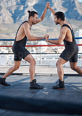 Buy stock photo Strong men, wrestling and push in ring with challenge, holding hands and focus for contest in Cape Town. Athlete, martial arts and grappling for mma, competition or fight in combat workout on rooftop