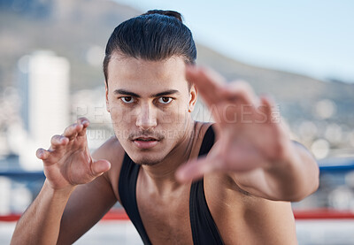 Fight, portrait and a man doing karate in the city, training for taekwondo or sports competition. Serious, fitness and a professional athlete with a move for a workout or martial arts exercise