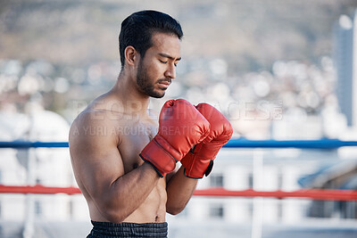 Buy stock photo Fitness, boxer praying or man fighting in a ring on rooftop in city for combat training or meditation. Eyes closed, Muay Thai athlete or Asian mma fighter ready for workout, exercise or match battle