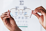 Hands, person and optometrist with glasses for vision, eye care and eyesight prescription. Closeup of optician, doctor and lens frame for eyewear, test and consulting of optical healthcare assessment