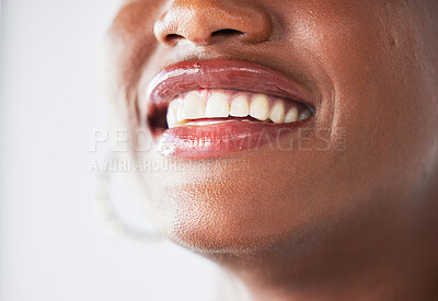 Buy stock photo Happy, lips and beauty with a woman closeup in studio on a gray background for makeup or cosmetics. Smile, mouth and teeth with a confident female person posing to promote dental health or hygiene