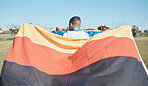 Germany, sports and man with a flag for soccer, motivation and training on a field. Back, fitness and professional athlete or person with representation of a country at a football game or competition