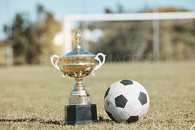 Buy stock photo Win, field and football and trophy for sports, game award and achievement in a contest. Fitness, grass and a prize or reward for soccer competition, championship or celebration of a goal at a stadium