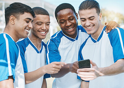 Buy stock photo Happy man, friends and soccer team with phone for social media, communication or online browsing outdoors. Group of football players smile on mobile smartphone app together after workout practice