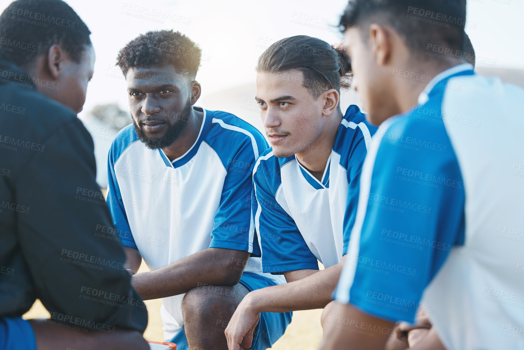 Buy stock photo Sports, huddle and soccer team talking to their coach before a match, training or tournament. Fitness, teamwork and male football player or athletes planning a game strategy at practice on a field.