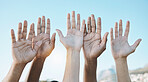 Diversity, palm of hands and group for outdoor celebration or team building together for support, motivation and solidarity. Raised hand, question or community of people on blue sky background