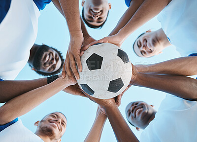 Soccer ball, support or team in a huddle for motivation, goals or group mission for a sports game or match. Smile, sky or low angle of happy football players in exercise, workout or fitness training