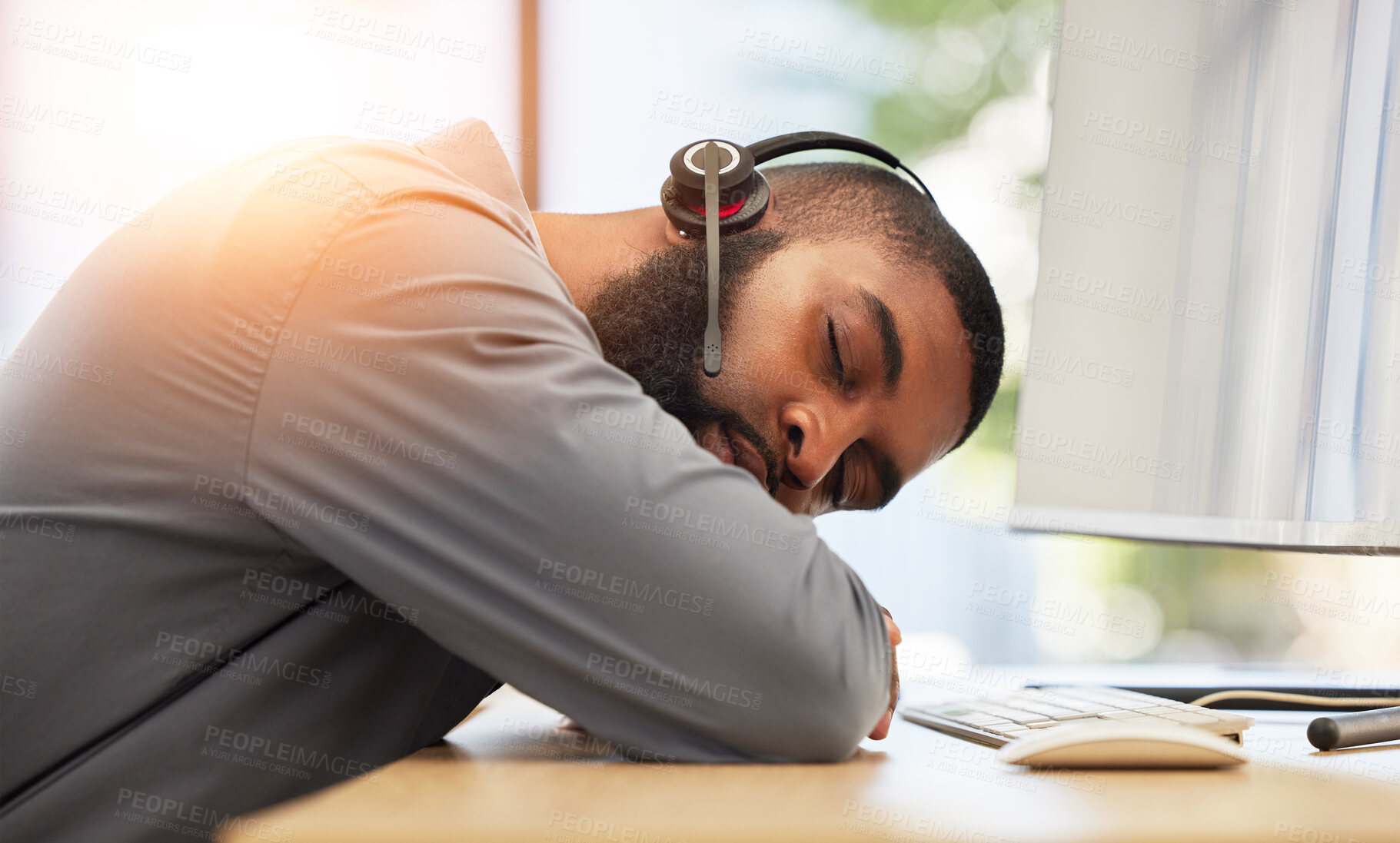 Buy stock photo Black man, sleeping on desk and tired call center employee, insomnia or mental health problem with headset and mic. Burnout, fatigue and male consultant with stress, nap at work with customer service