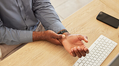 Buy stock photo Hand, wrist pain and a business black man at his desk in the office with an injury while working on a keyboard. Arthritis, injury or carpal tunnel with an employee sitting at his workplace from above