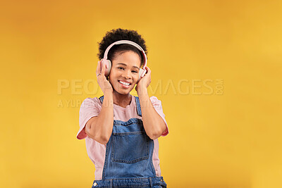 Buy stock photo Headphones, music and black woman in portrait, smile and isolated in studio on a yellow background mockup space. Face, happy and person listening to radio, podcast or sound for jazz, hip hop or audio