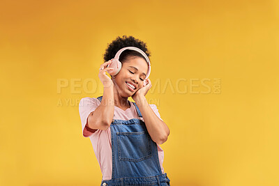 Buy stock photo Music, headphones and happy black woman listening in studio isolated on a yellow background mockup space. African person, smile or hearing radio, podcast or sound for jazz, hip hop or streaming audio