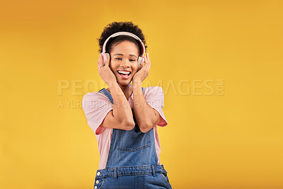 Buy stock photo African girl, headphones and studio portrait with smile, youth fashion and sound by yellow background. Young student, gen z woman or model with audio tech, streaming subscription and happy for music