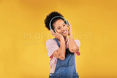 Buy stock photo Music, headphones and happy black woman in portrait listening in studio isolated on a yellow background mockup space. Face, smile and person hearing radio, podcast or sound for jazz, hip hop or audio