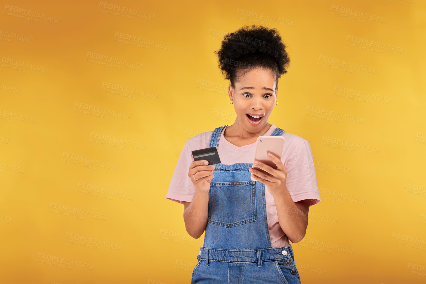 Buy stock photo Woman, credit card and wow with phone, studio and shock face for deal, discount or sale by yellow background. Gen z girl, smartphone and banking with surprise for investment, scam and fintech app