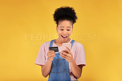 Buy stock photo Woman, credit card and surprise with phone, studio and shock face for deal, discount or sales by yellow background. Gen z girl, cell phone and banking with wow for investment, smile and fintech app
